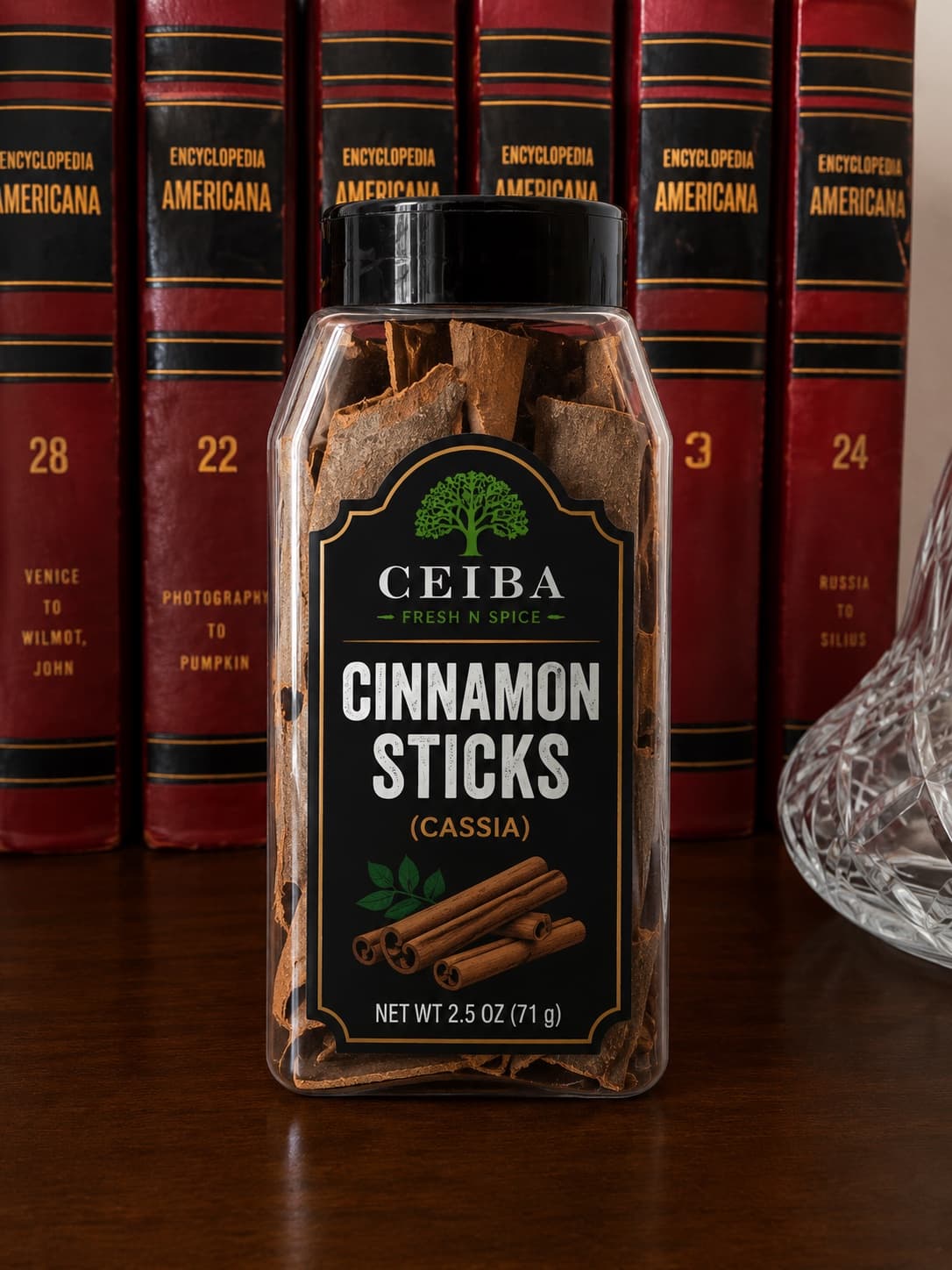Ceiba cassia cinnamon sticks jar in front of a row of encyclopedias